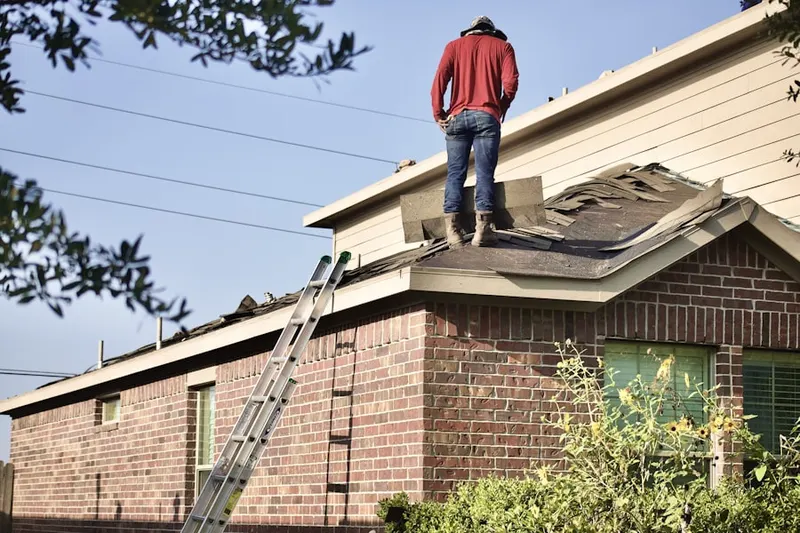 Professional roofer working on a residential roof in Katy